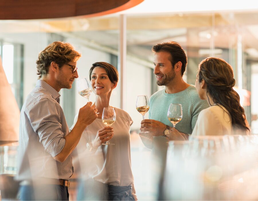 Friends toasting with white wine in a tasting room