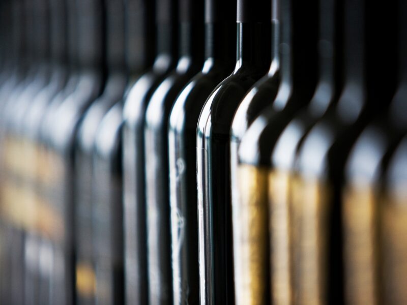 Row of dark wine bottle necks