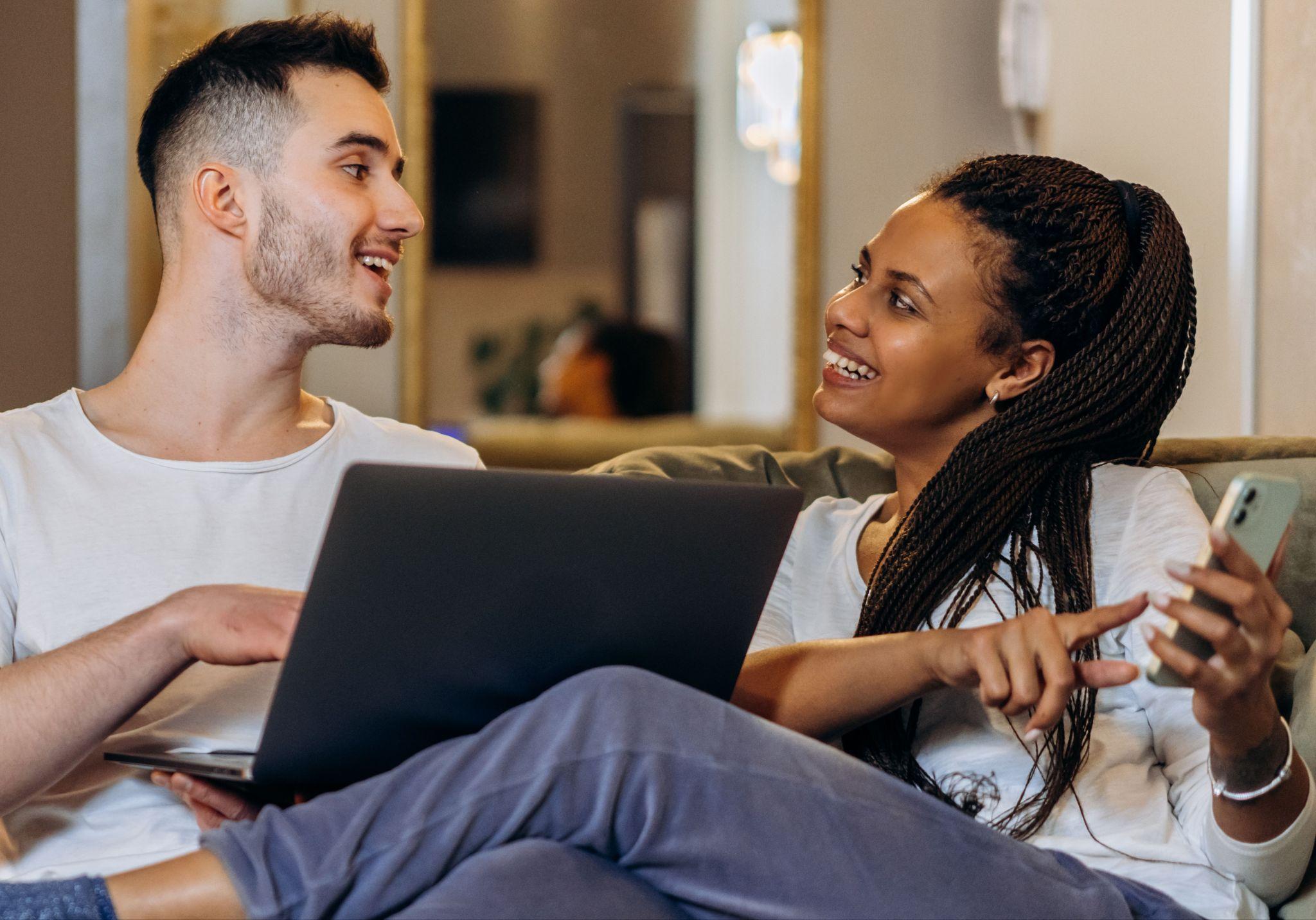 Couple reading answers on a laptop at home
