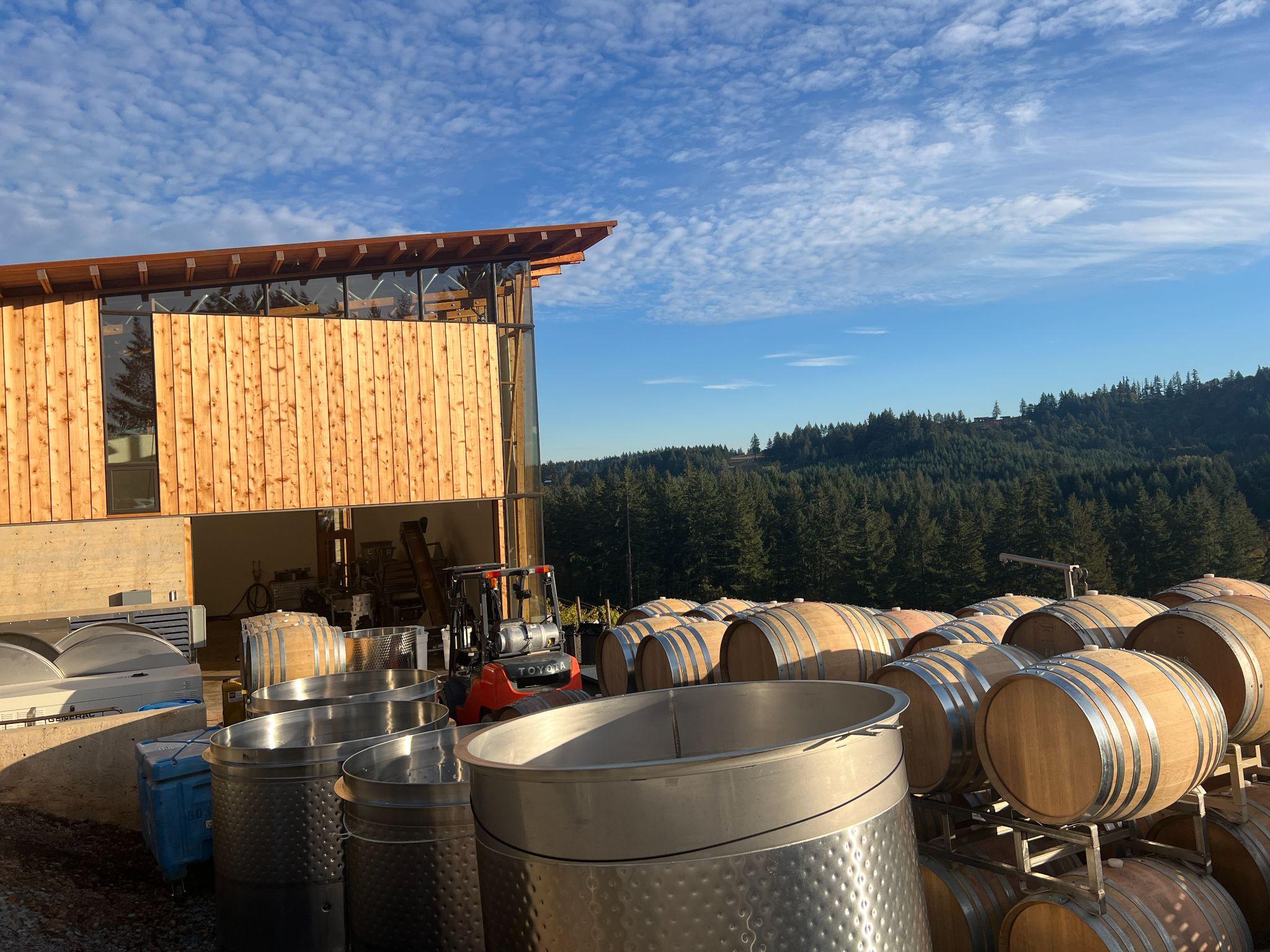 Winery crush pad with steel tanks and barrels
